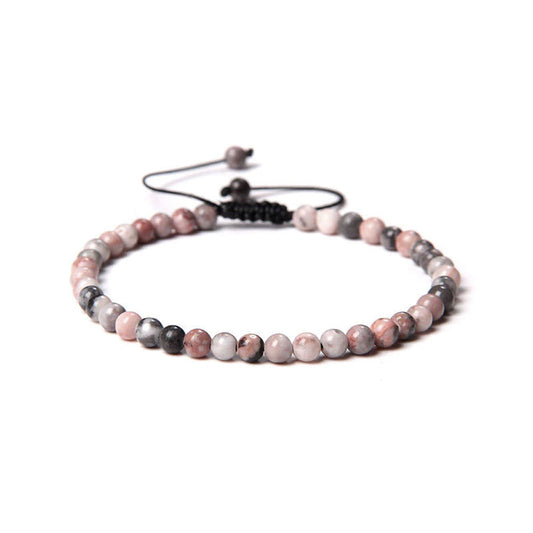 Bracciale in Rodonite – cordino regolabile con pietre sferiche